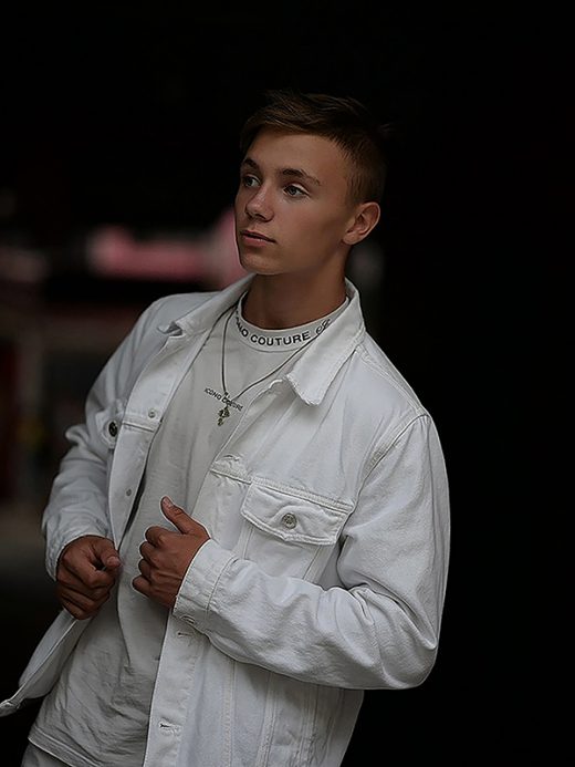 Style blond boy in white jacket